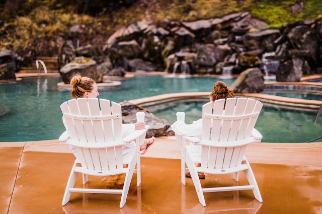 Two people relaxing on chairs next to Quinns Hot Springs